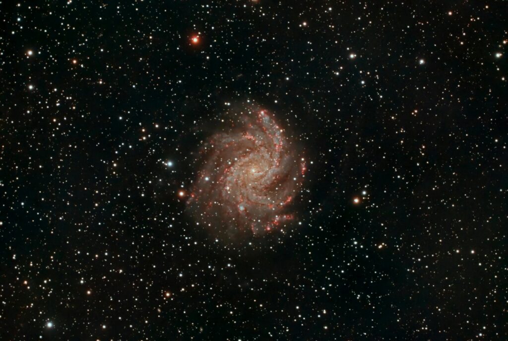 Capture of a spiral galaxy surrounded by stars, showcasing the vastness of space.